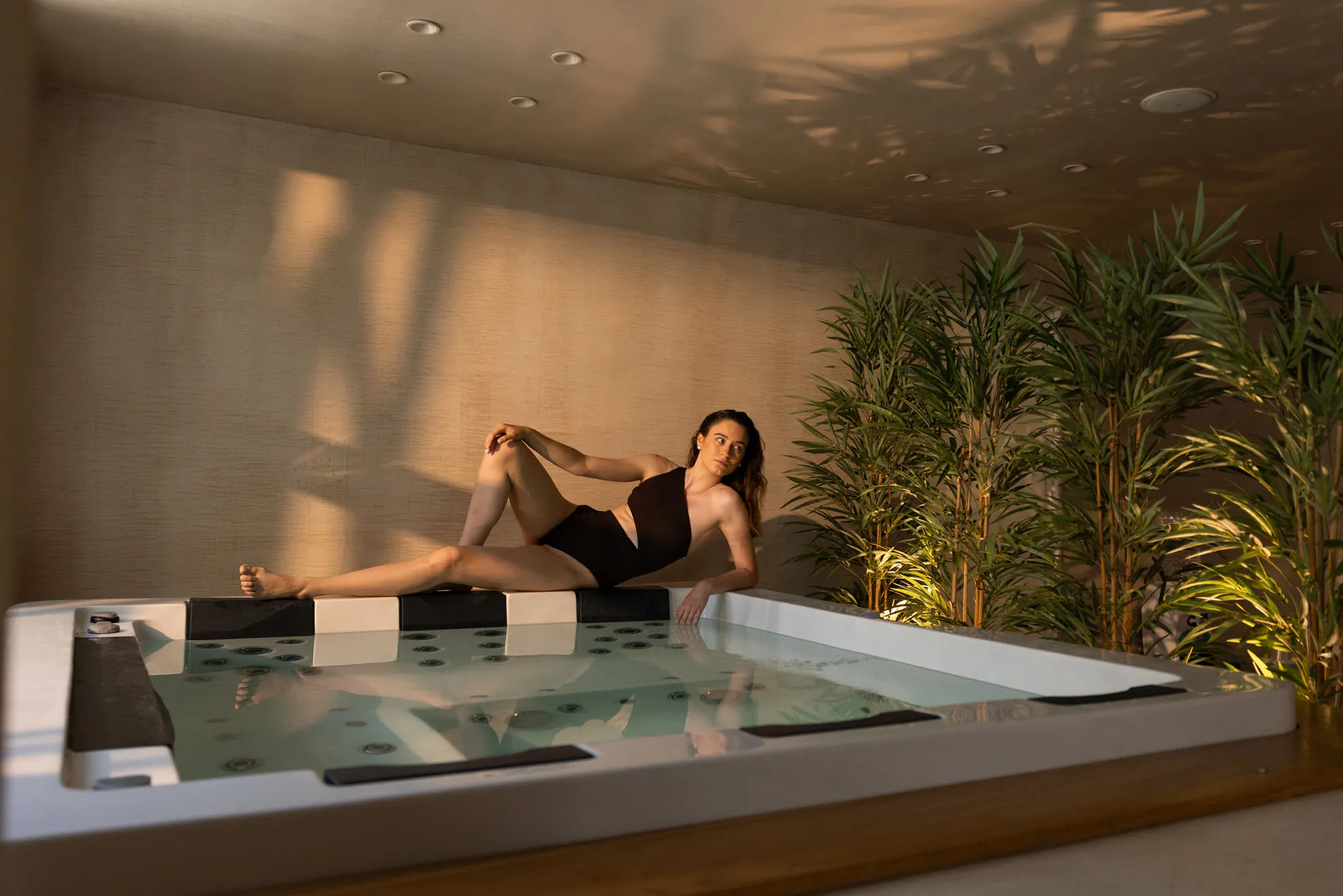 Guest relaxing by the indoor jacuzzi at Nefeli Hotel